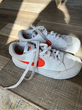 Nike White Low-Top Sneakers with Orange Swoosh